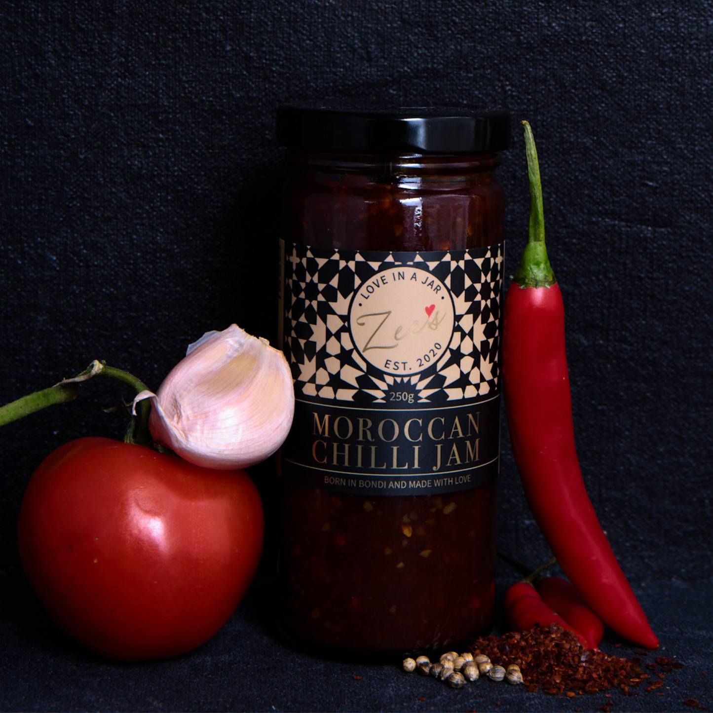 Jar of Moroccan Chilli Jam with ingredients on a dark background