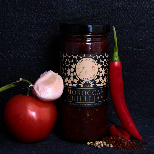 Jar of Moroccan Chilli Jam with ingredients on a dark background